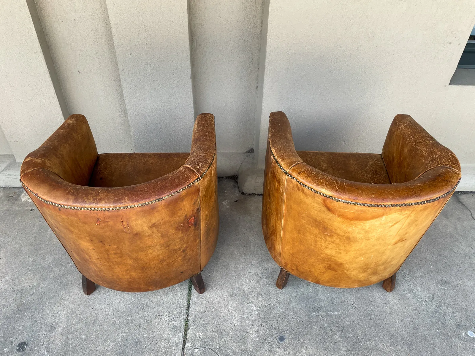 Pair Vintage European Leather Tub Chairs with Brass Nailhead Detail